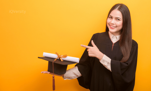 Smiling girl holding graduation cap